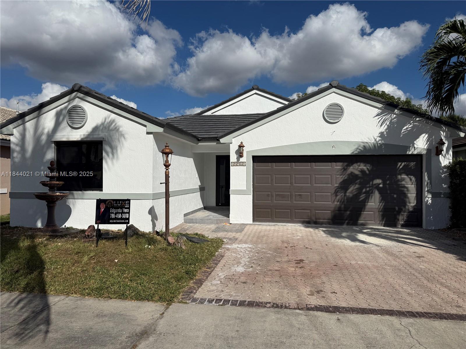 15921 Southwest 82nd Street Miami, FL 33193 - Photo 2 of 22 a front view of a house with a garage