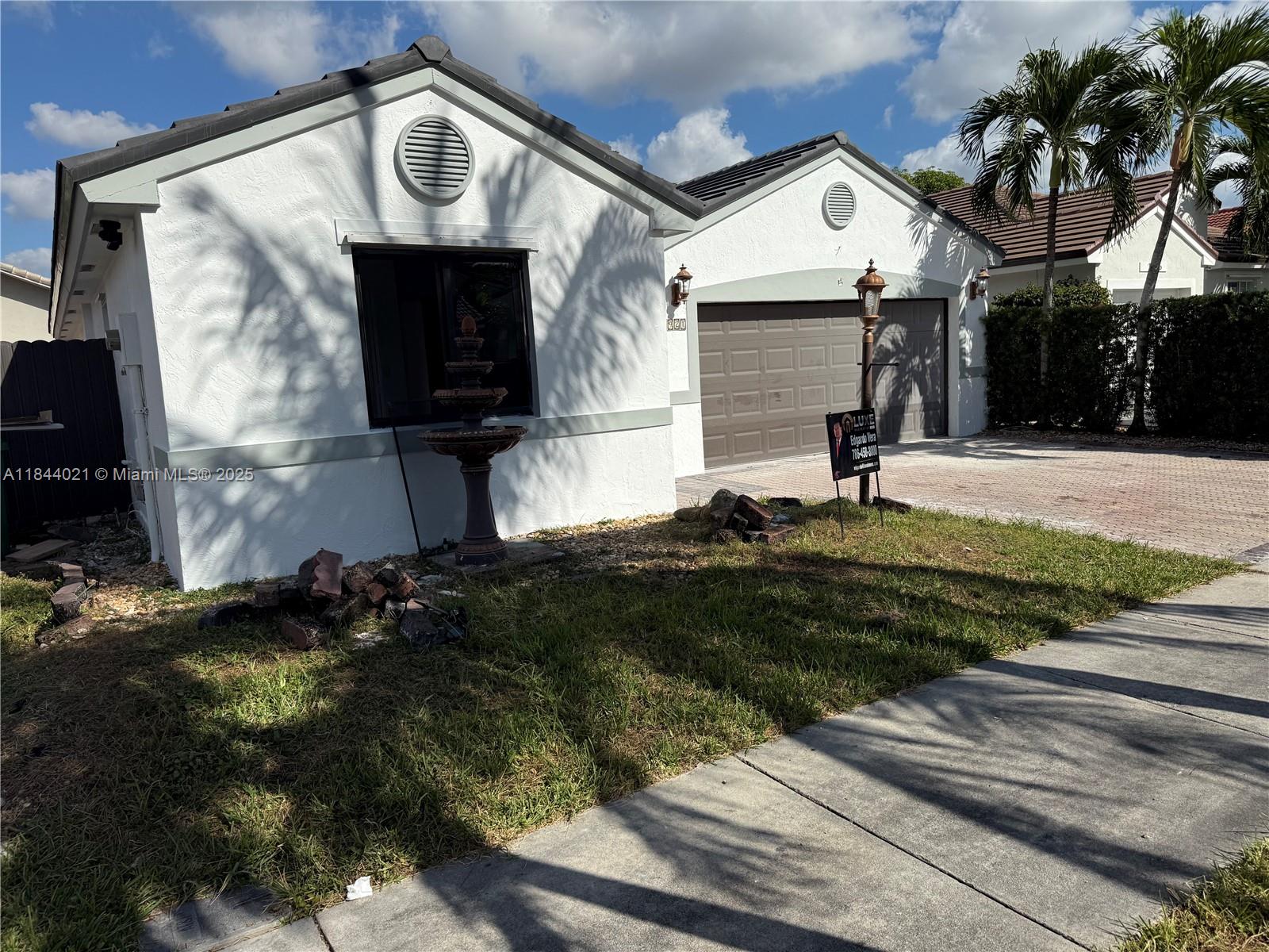 15921 Southwest 82nd Street Miami, FL 33193 - Photo 6 of 22 a front view of a house with garden