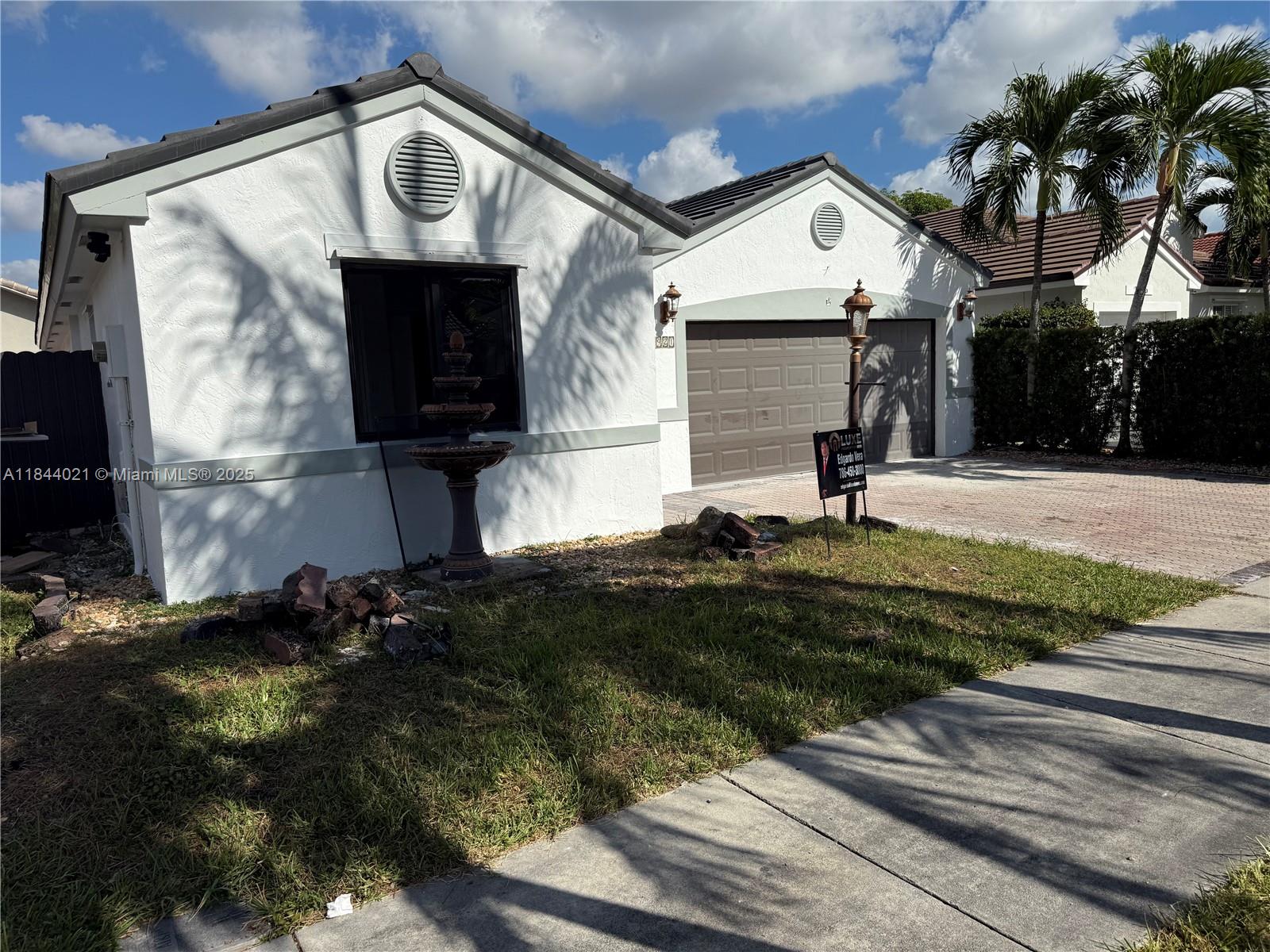 15921 Southwest 82nd Street Miami, FL 33193 - Photo 7 of 22 a front view of a house with a yard