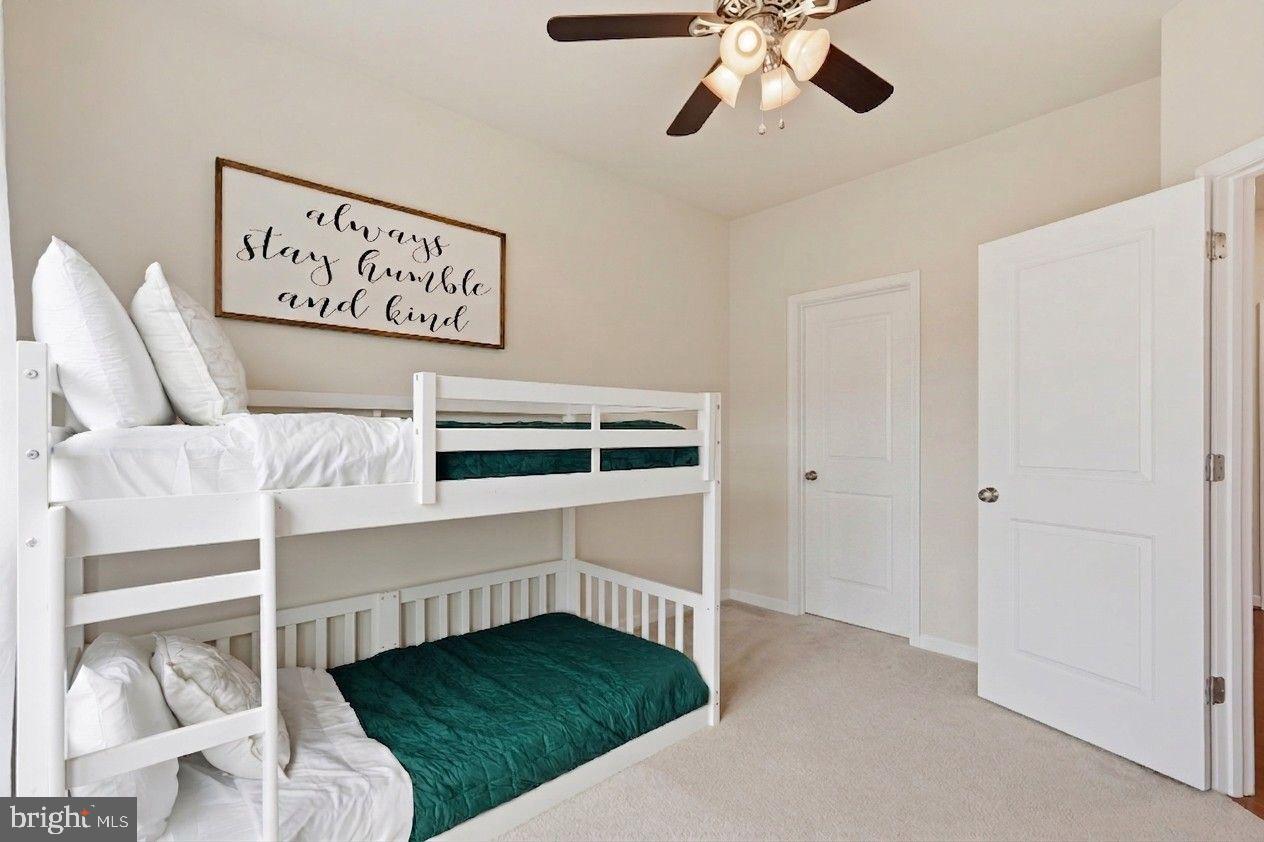 204 Miles Hawk Terrace Purcellville, VA 20132 - Photo 27 of 40 a bedroom with a bed and a chandelier