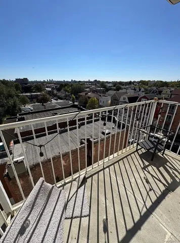 a view of balcony with wooden floor and city view