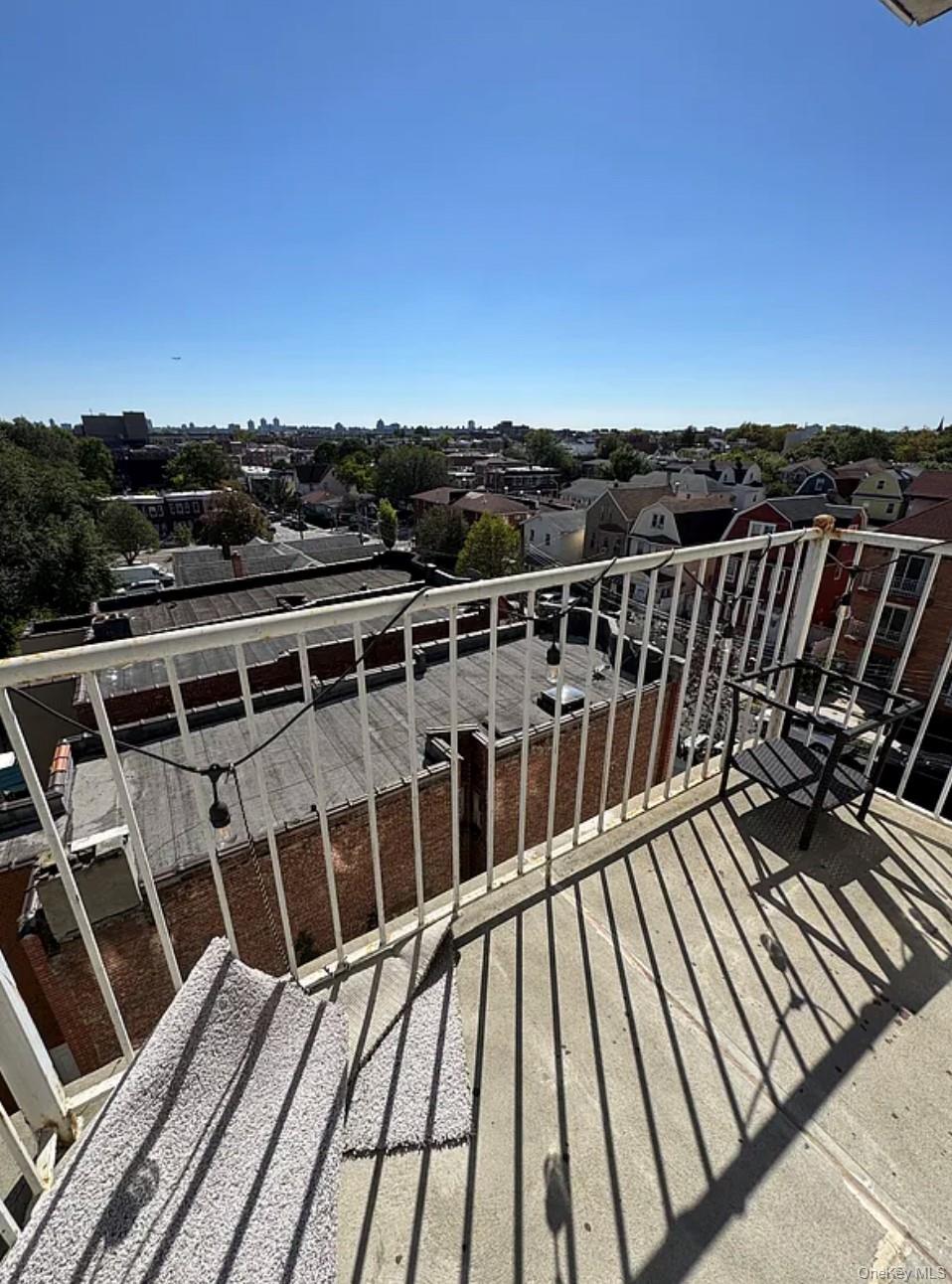 112-02 Northern Boulevard, Unit 6C Queens, NY 11368 - Photo 6 of 6 a view of balcony with wooden floor and city view