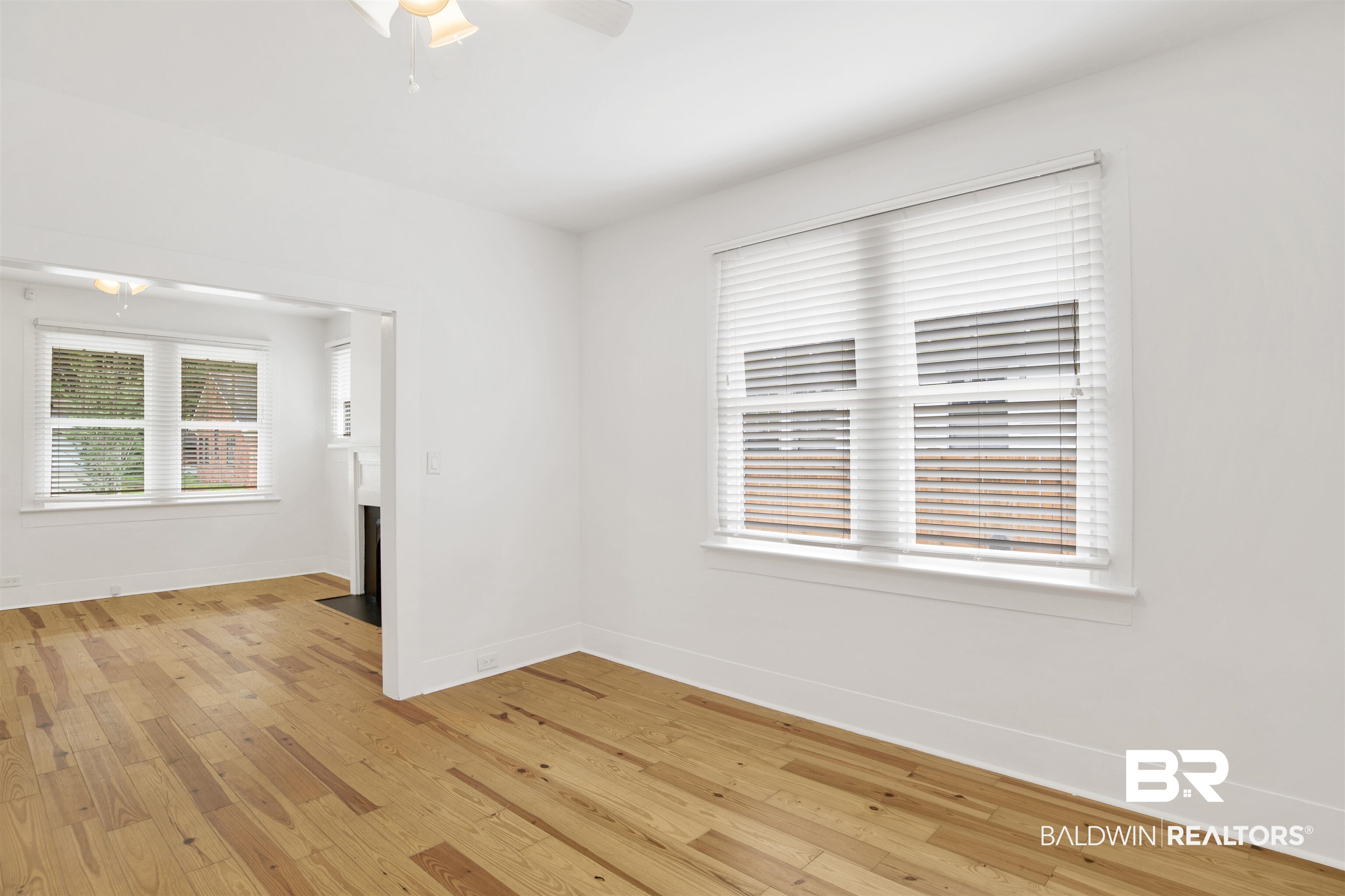507 Holcombe Avenue Mobile, AL 36606 - Photo 16 of 28 Spare room featuring light wood-style flooring, baseboards, and a ceiling fan