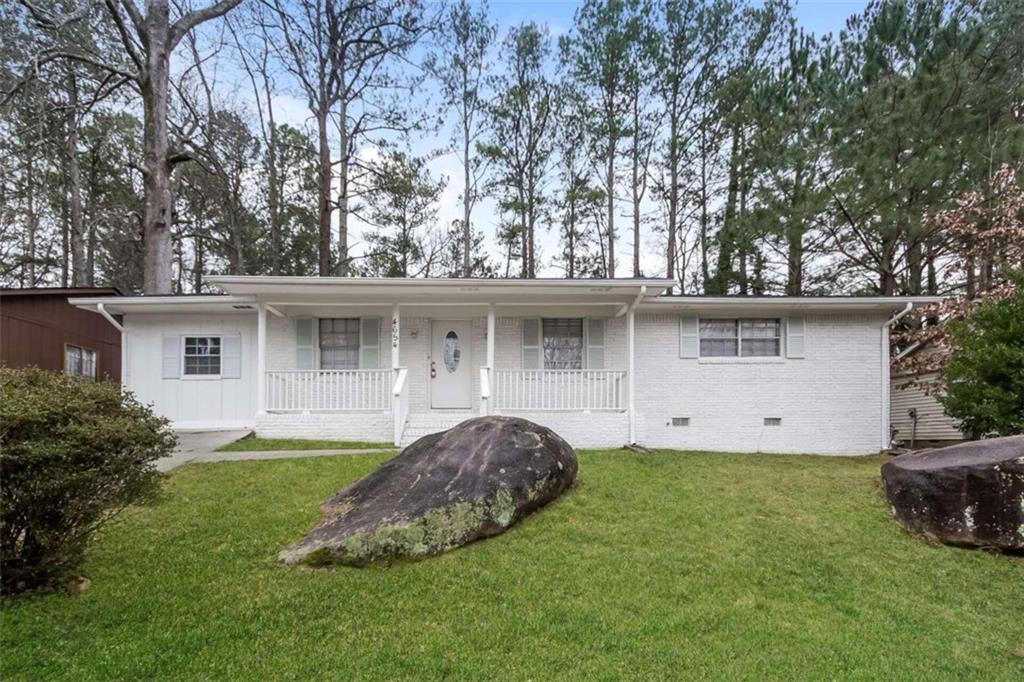 4654 Greenbriar Trail Southwest Atlanta, GA 30331 - Photo 1 of 1 a front view of a house with a garden and trees