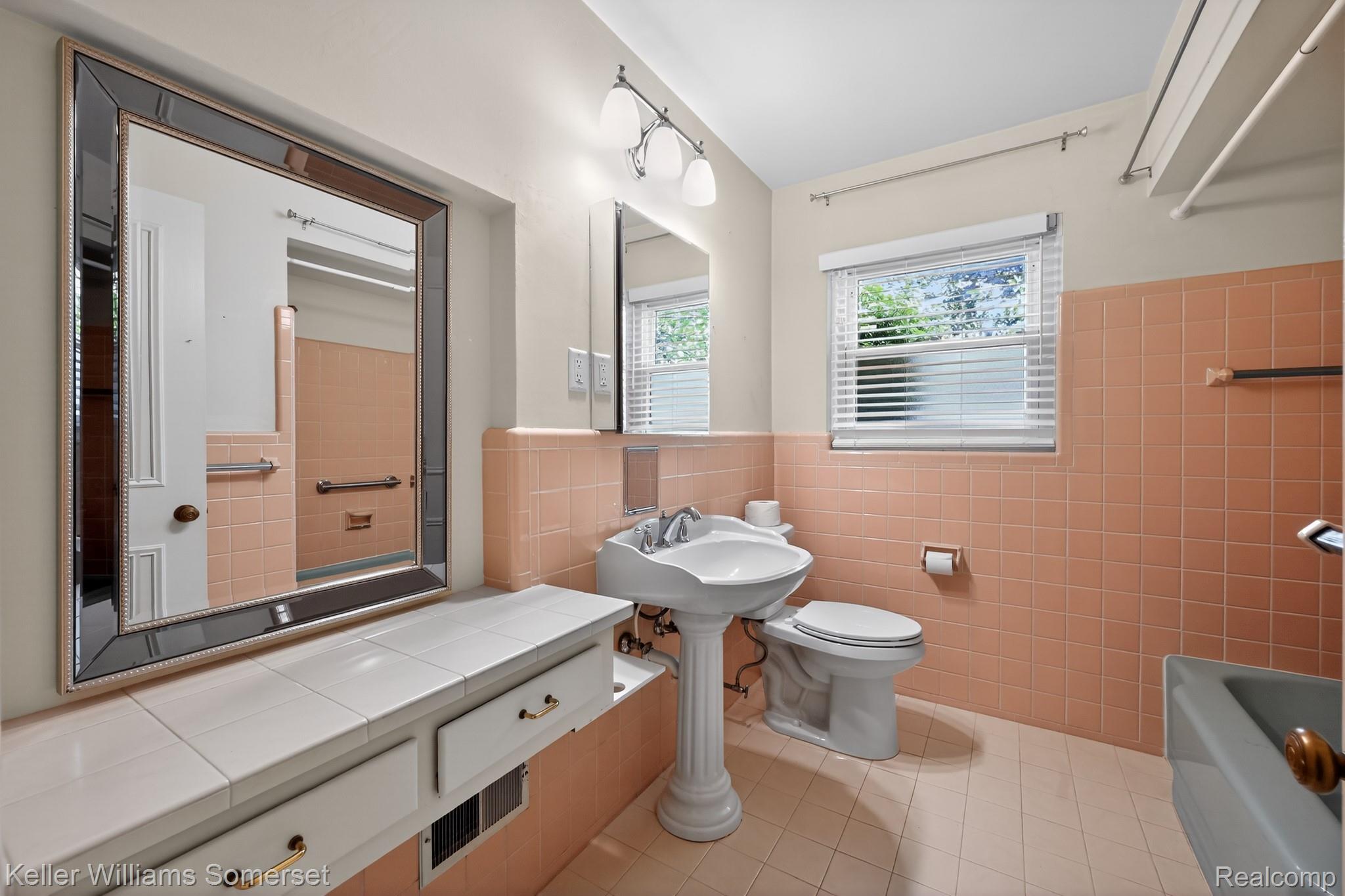 1681 Oxford Road Grosse Pointe, MI 48236 - Photo 16 of 25 Full bathroom with tile walls, a wainscoted wall, light tile patterned floors, and shower / bath combination