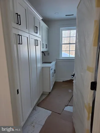 a kitchen with cabinets and a refrigerator