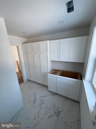 a living room with a couch and a washer dryer