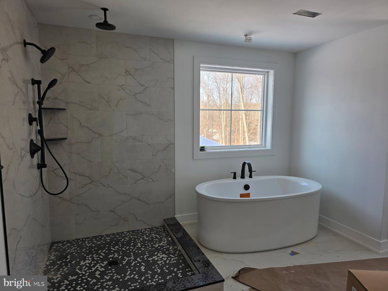 5987 Point Pleasant Pike Doylestown, PA 18902 - Photo 16 of 20 a white bath tub sitting in a bathroom next to a window