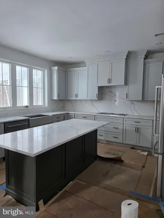 a kitchen with a sink window and cabinets
