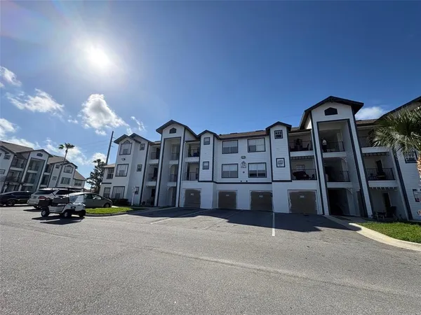 a view of a building with cars parked