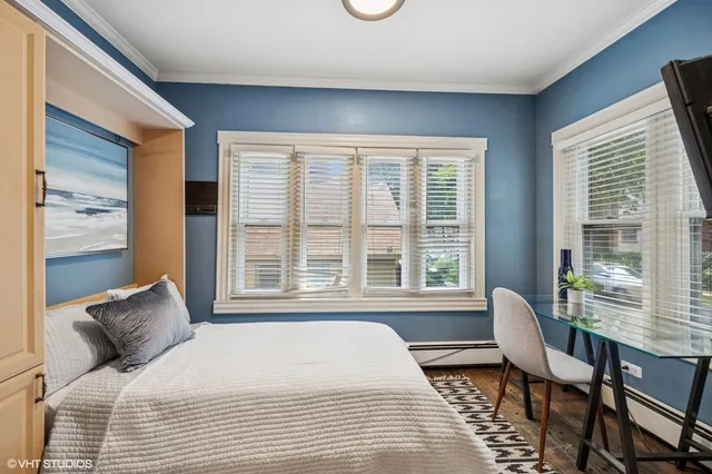 a living room with furniture a large window and a fireplace