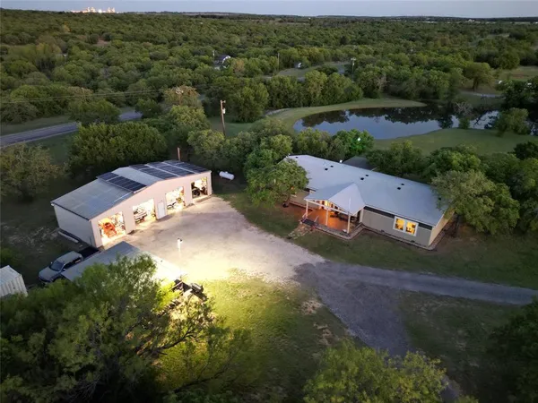 an aerial view of a house with a yard