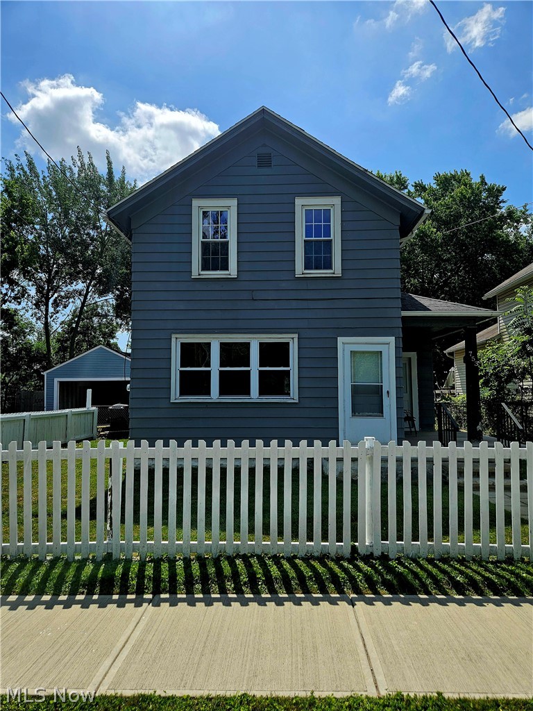 753 West River Road North Elyria, OH 44035 - Photo 1 of 28 Two-story residence featuring blue siding, white trim, and a prominent white picket fence