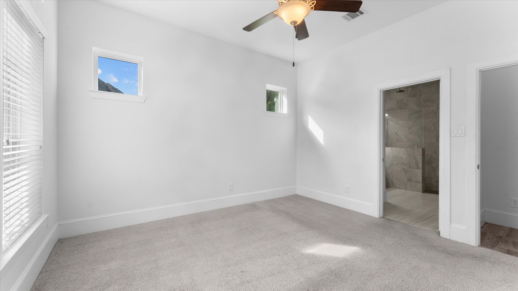 32001 Birch Briar Court Spring, TX 77386 - Photo 30 of 48 Spacious secondary bedroom featuring abundant natural light, plush carpeting, and a generous closet, perfect for family or guests.