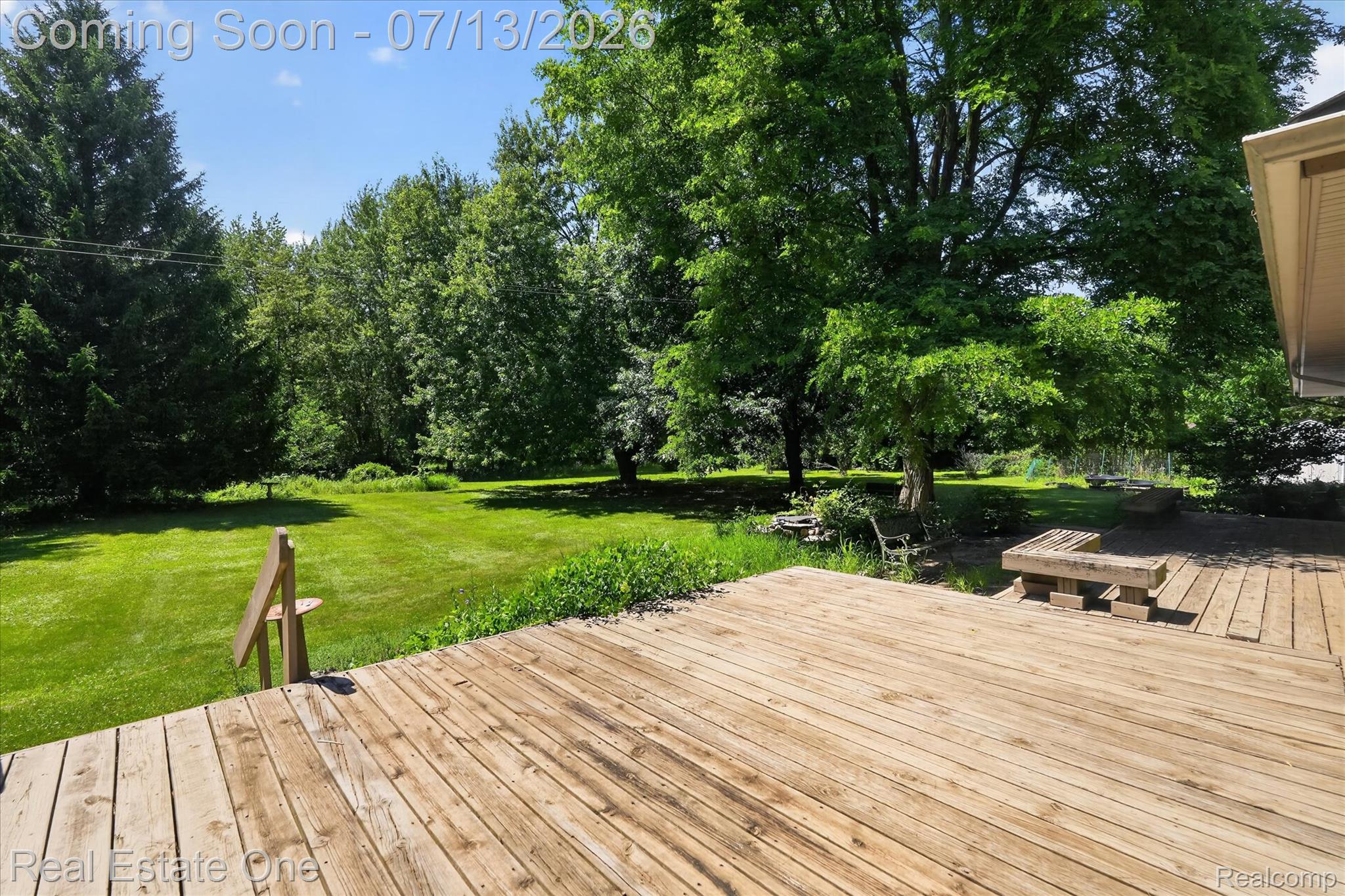 6039 Fish Lake Road Holly, MI 48442 - Photo 48 of 70 Expansive wooden deck overlooking a large lawn with mature trees