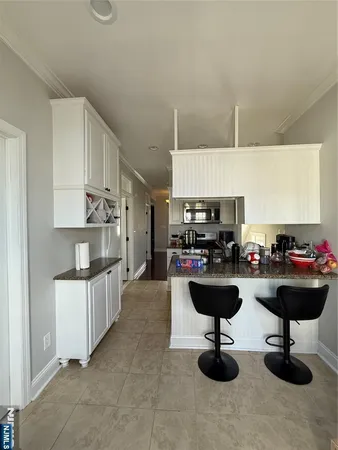 a view of a kitchen with kitchen island granite countertop living room