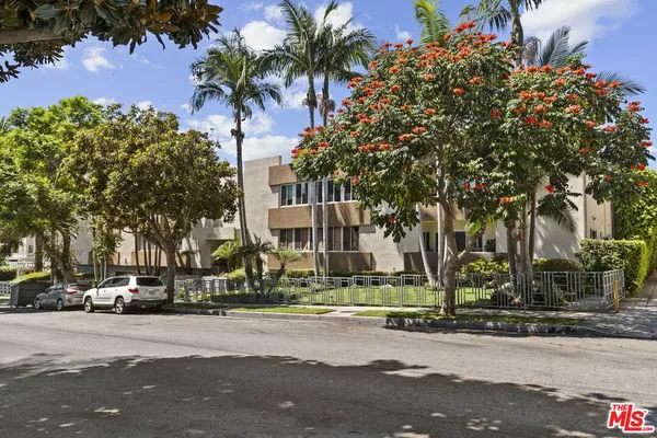 a city street lined with buildings and trees