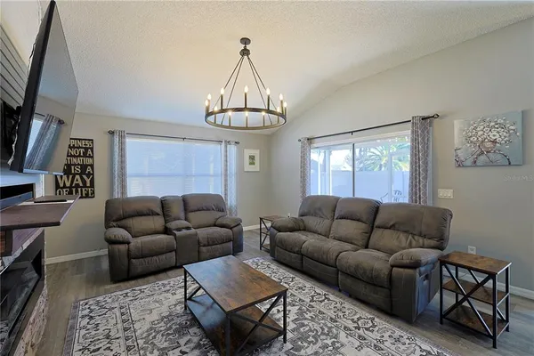 a living room with furniture a rug and a window