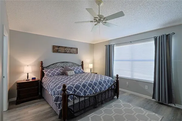a bedroom with a large bed and a window