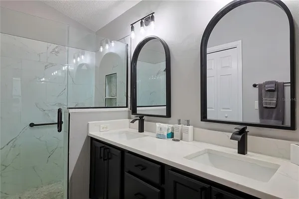 a bathroom with a double vanity sink and a mirror