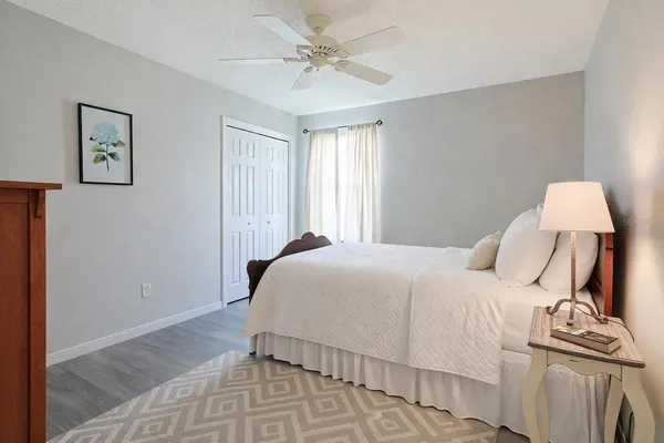 a bedroom with a bed and a lamp on table
