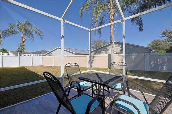 a view of a patio with table and chairs with wooden floor