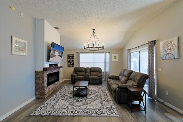 a living room with furniture windows and a rug