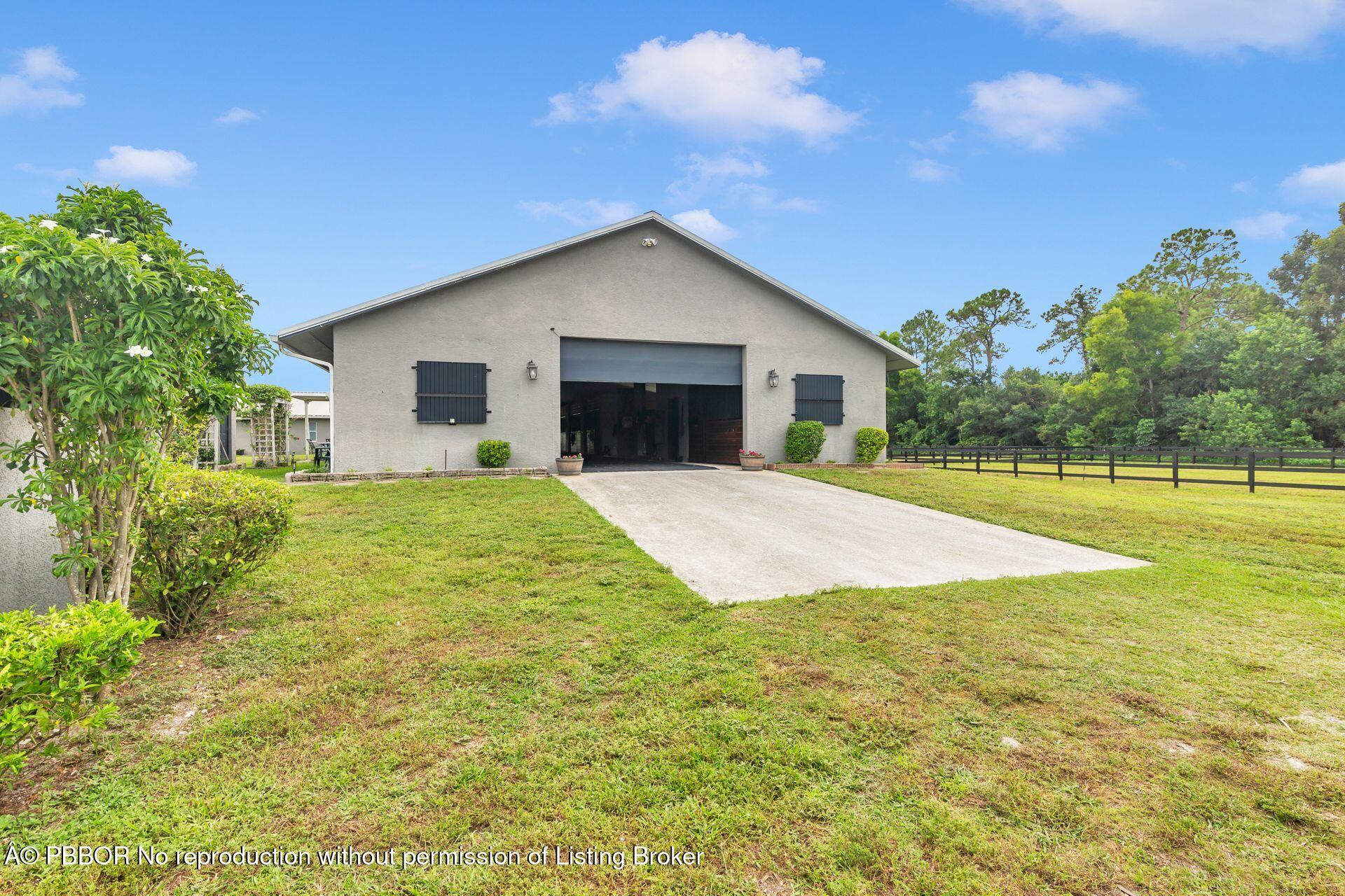 2770 E Road Loxahatchee, FL 33470 - Photo 5 of 51 a house with swimming pool in front of it