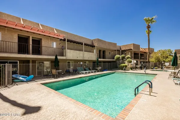 a swimming pool with outdoor seating and yard