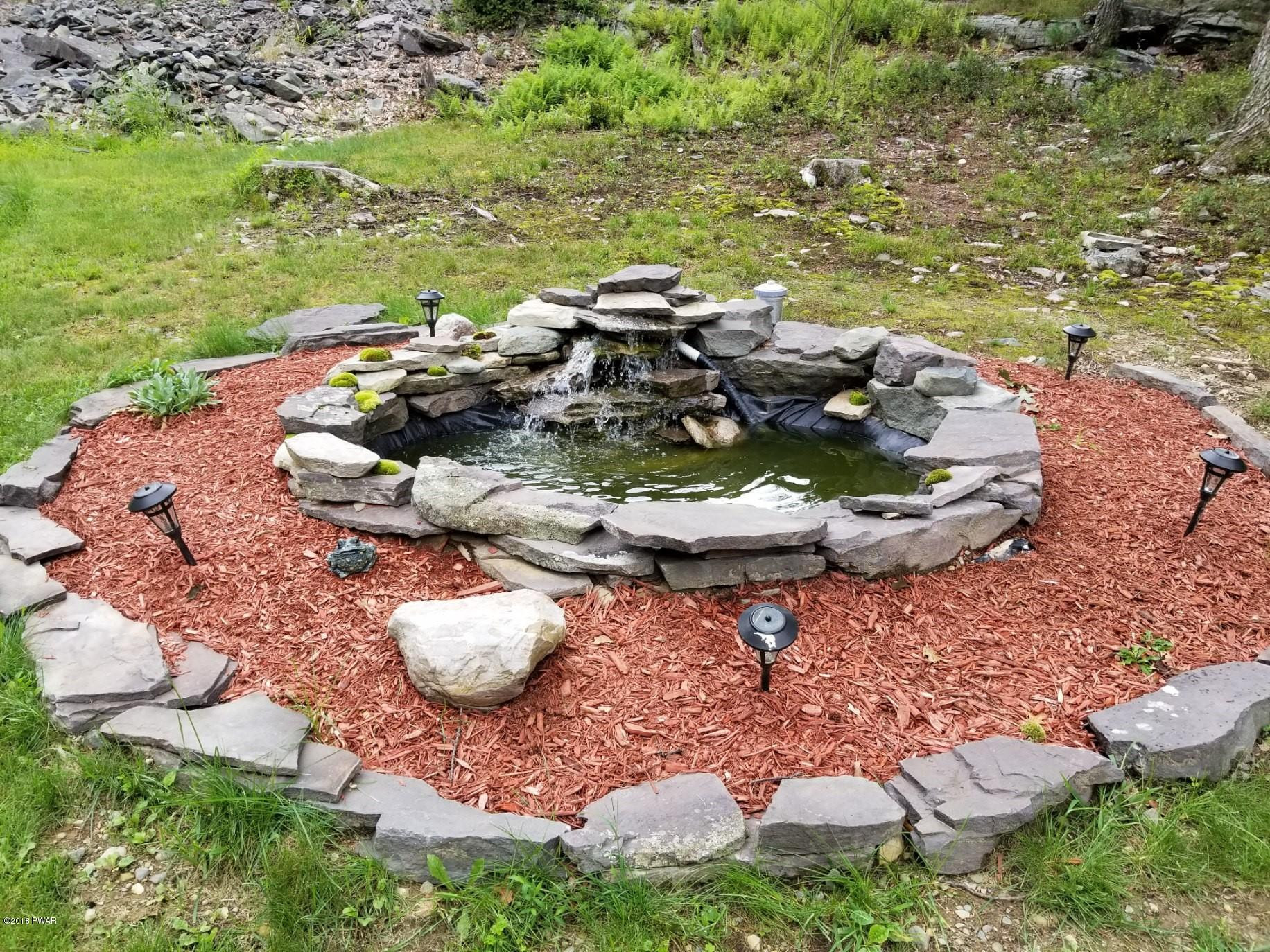 141 Weasel Road Dingmans Ferry, PA 18328 - Photo 27 of 28 a table and chairs and garden in the outdoor