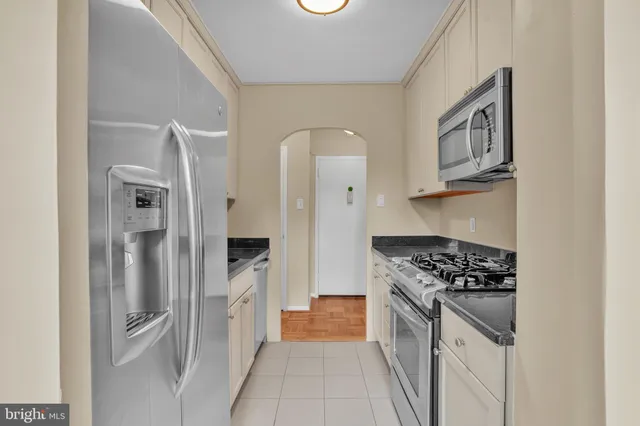 a kitchen with cabinets and stainless steel appliances