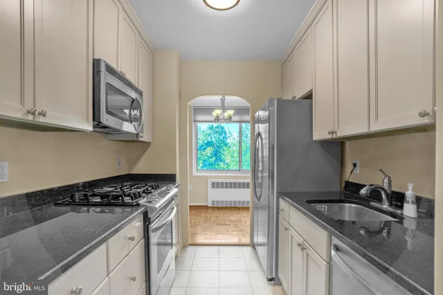 a kitchen with granite countertop a stove and a sink