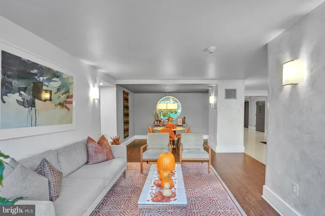 a living room with furniture and a clock