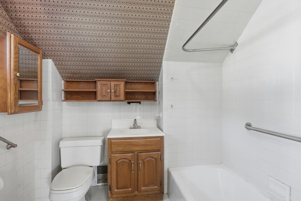 46 Wilfred Street Lynn, MA 01905 - Photo 23 of 29 a bathroom with a toilet a sink and bathtub