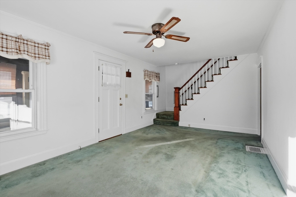 46 Wilfred Street Lynn, MA 01905 - Photo 8 of 29 an empty room with windows and stairs