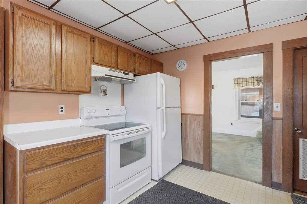 46 Wilfred Street Lynn, MA 01905 - Photo 9 of 29 a kitchen with a stove a refrigerator and a sink