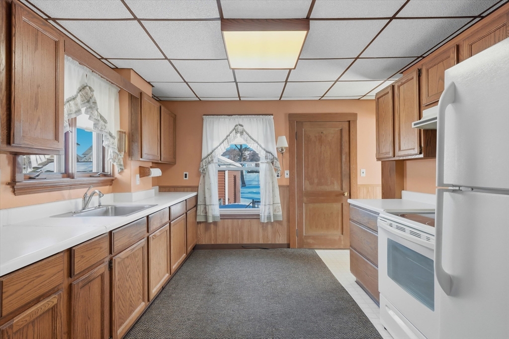 46 Wilfred Street Lynn, MA 01905 - Photo 10 of 29 a kitchen with a sink and refrigerator