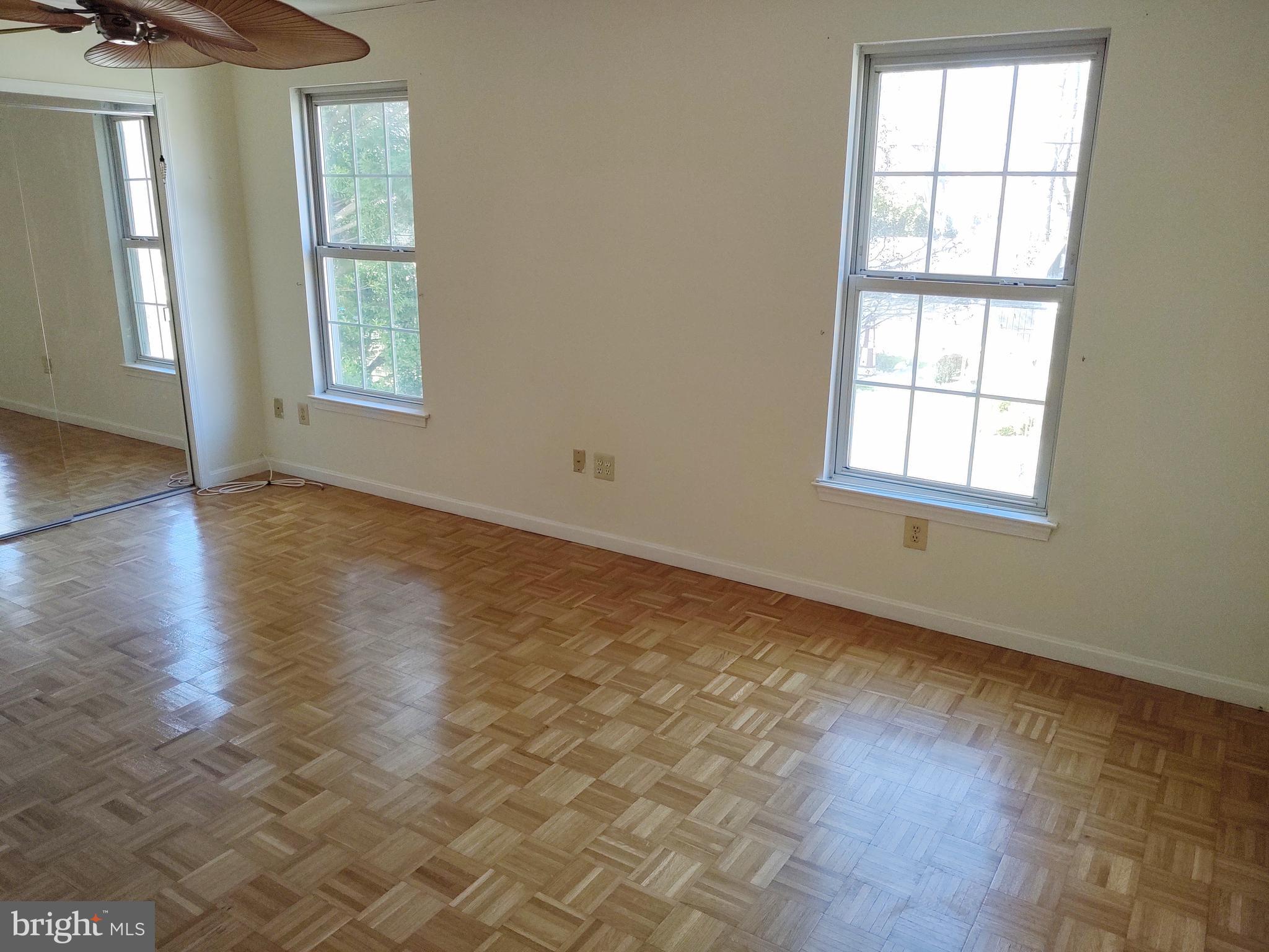 609 Mann Road Deale, MD 20751 - Photo 14 of 24 an empty room with wooden floor and windows