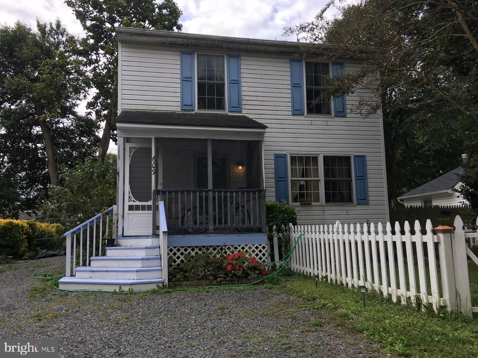 609 Mann Road Deale, MD 20751 - Photo 2 of 24 a view of a house with wooden fence and a porch
