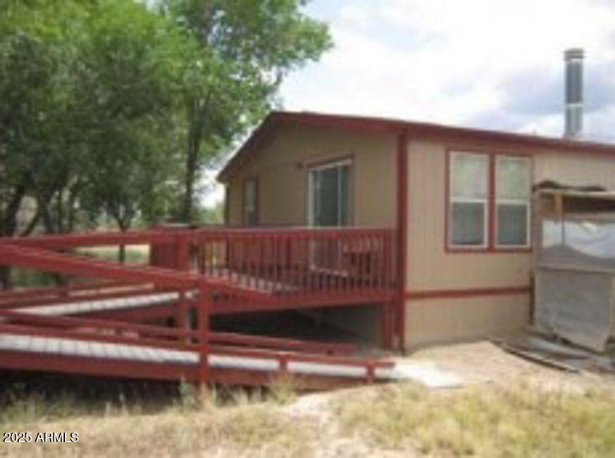 1495 Buffalo Run Road Chino Valley, AZ 86323 - Photo 19 of 20 a view of backyard with deck and wooden fence