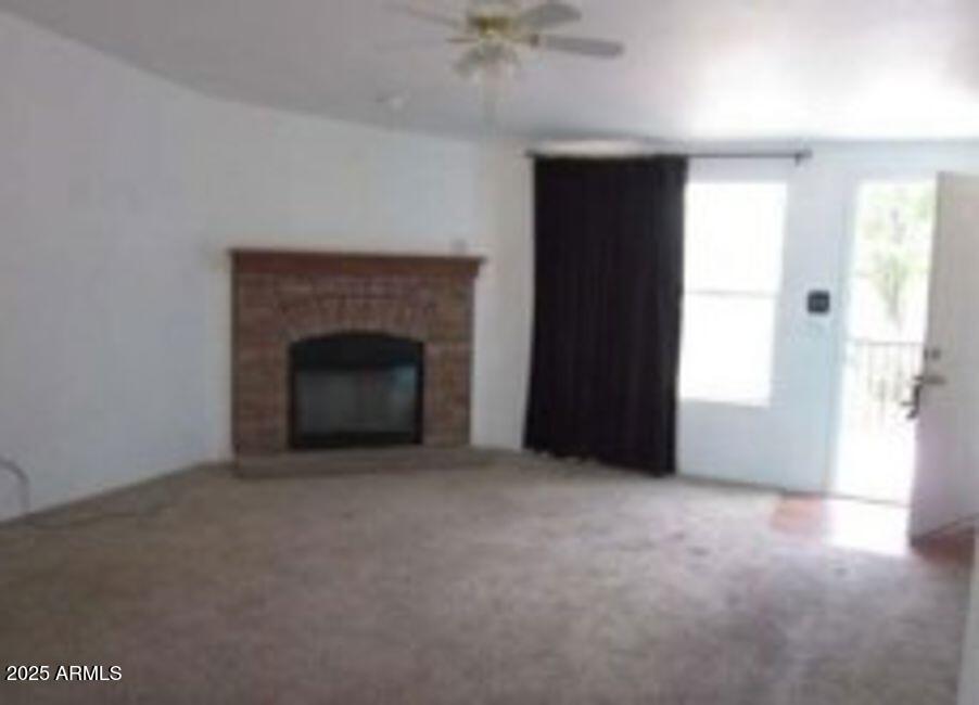 1495 Buffalo Run Road Chino Valley, AZ 86323 - Photo 7 of 20 an empty room with windows and fireplace