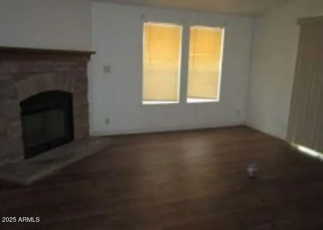 a view of empty room with window and fireplace