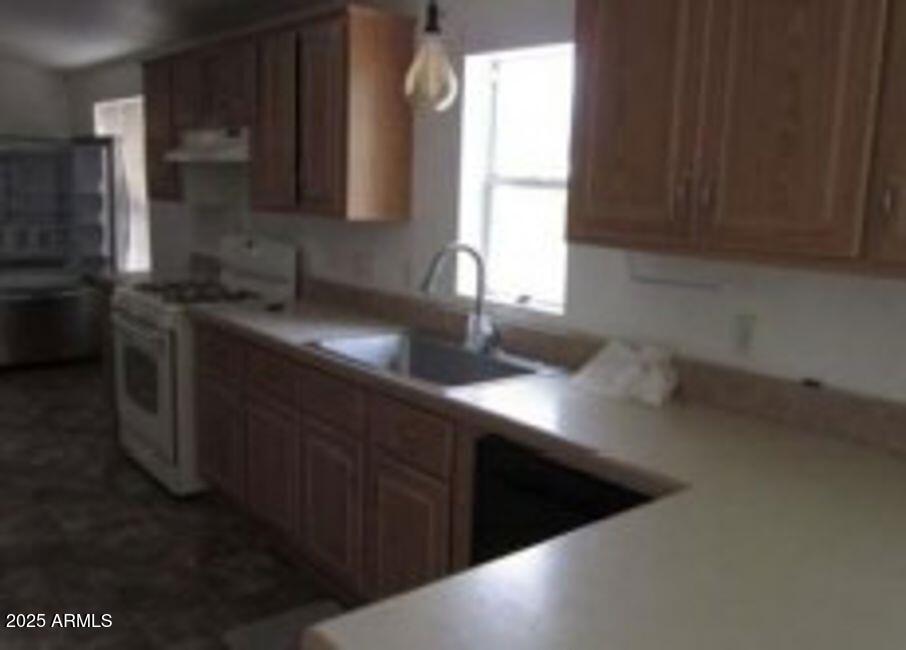 1495 Buffalo Run Road Chino Valley, AZ 86323 - Photo 9 of 20 a kitchen with a sink a window and cabinets