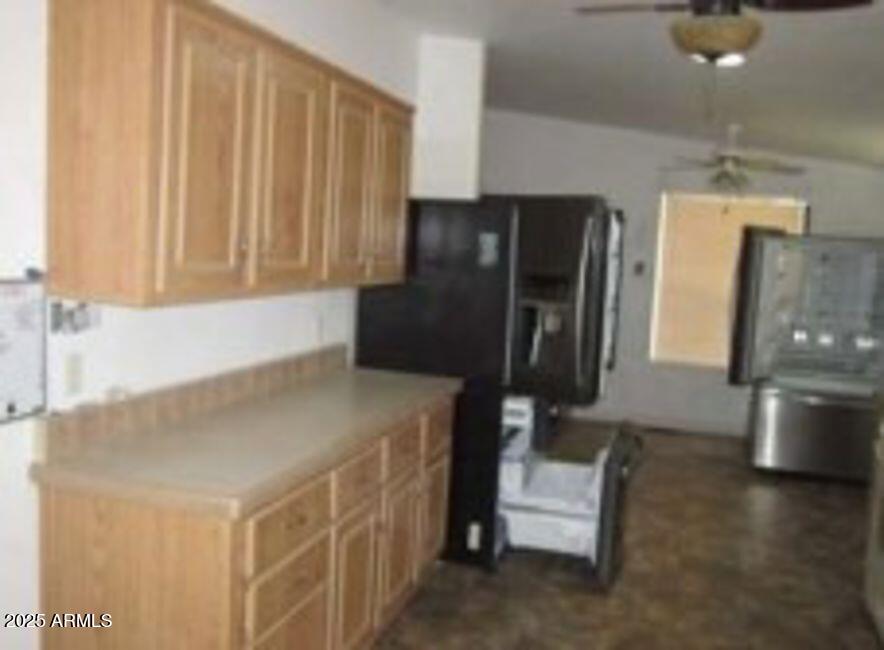 1495 Buffalo Run Road Chino Valley, AZ 86323 - Photo 10 of 20 a kitchen with water heater and wooden cabinets