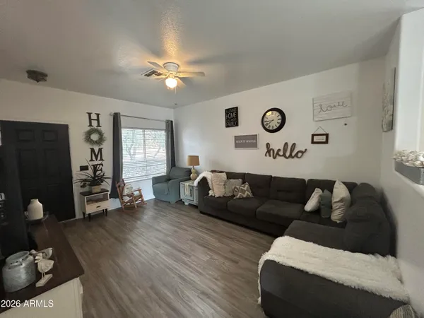 a living room with furniture and wooden floor