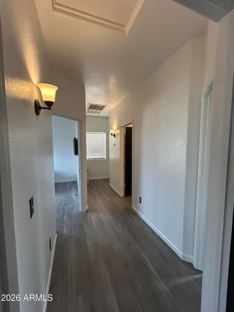 a view of a hallway with wooden floor