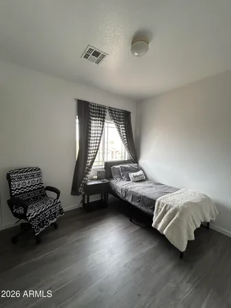a bedroom with a bed and a window