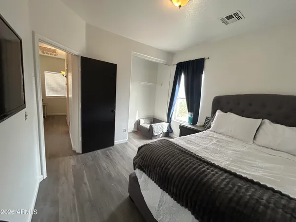 a bed sitting in a bedroom next to a window