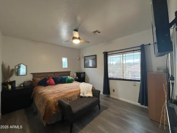 a bedroom with a bed and a view of kitchen