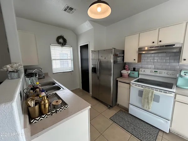 a kitchen with a stove and a refrigerator